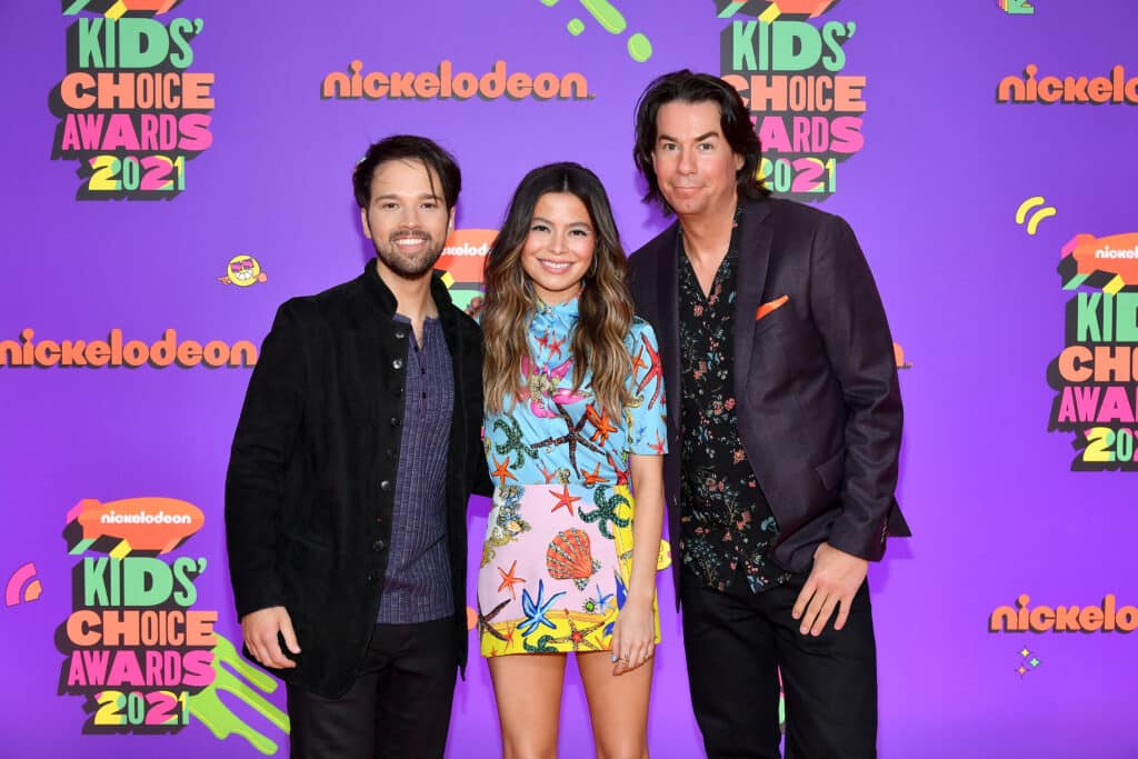 In this image released on March 13, (L-R) Nathan Kress, Miranda Cosgrove and Jerry Trainor attend Nickelodeon's Kids' Choice Awards at Barker Hangar on March 13, 2021 in Santa Monica, California.
