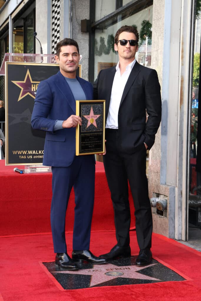 US actor Zac Efron (L) poses with Miles Teller during his Hollywood Walk of Fame ceremony in Hollywood, California, December 11, 2023.