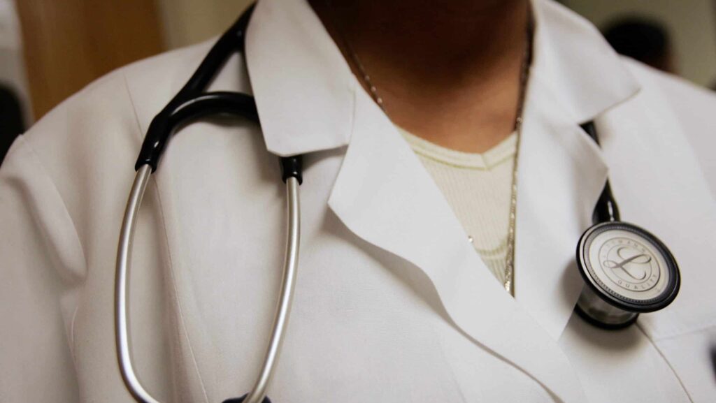 DORCHESTER - APRIL 05: Dominique Entzminger, a physician assistant of family medicine, wears a stethoscope during an examination at the Codman Square Health Center April 5, 2006 in Dorchester, Massachusetts. State lawmakers approved a health care reform bill March 4 that would make Massachusetts the first state in the nation to require all its citizens have some form of health insurance. Governor Mitt Romney is scheduled to sign the bill next week.