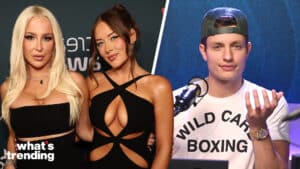 Two women in black dresses posing at an event and a man in a Wild Card Boxing shirt speaking into a microphone