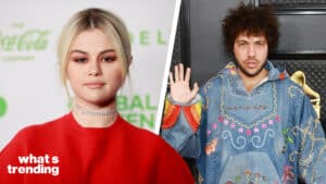 Selena Gomez in a red top and Benny Blanco in a colorful embroidered denim jacket at a music event.