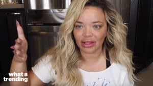 Trisha Paytas speaking with a raised hand in a kitchen setting with "what's trending" logo.