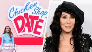 Emma Stone presenting in front of a Chicken Shop Date logo next to a photo of Cher wearing a black sequined hat and jacket