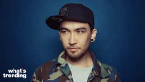 YouTuber turned major director Mark Diva poses in front of a blue background.