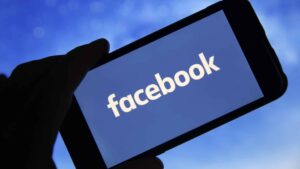In this photo illustration the Facebook logo is seen on the screen of an iPhone on January 31, 2019 in Paris, France. The social media Facebook revealed to have paid teenagers to watch their activities on their phone. The company has offered Internet users to download the application "Facebook Research" to observe all their deeds and actions, against payment. Despite this, Facebook shares soar by 11% in the wake of the announcement of a net profit up 61% to $ 6.9 billion for the last quarter of 2018.