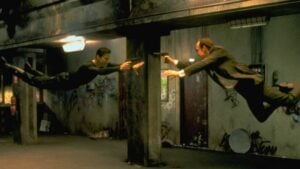 Keanu Reeves and Hugo Weaving face each other in a scene from Andy and Larry Wachowski's 1999 movie The Matrix. In this scene, Neo (Reeves) fights the computerized Agent Smith