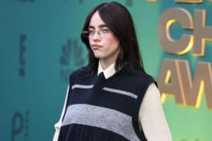 Billie Eilish wearing glasses and a black and gray sweater vest at the Critics Choice Awards