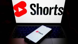 The YouTube Shorts logo is being displayed on a smartphone screen and on a computer screen in Athens, Greece, on May 8, 2024.