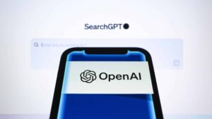 Logo of OpenAI is displayed on a smartphone backdropped by ''SearchGPT'' featured on its webpage. OpenAI announced on Thursday its SearchGPT prototype. ''We're testing SearchGPT, a prototype of new search features designed to combine the strength of our AI models with information from the web to give you fast and timely answers with clear and relevant sources. We're launching to a small group of users and publishers to get feedback. While this prototype is temporary, we plan to integrate the best of these features directly into ChatGPT in the future,'' OpenAI said