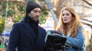 Blake Lively and director Justin Baldoni were caught in a tense conversation on set while filming 'It Ends With Us.' The scene, featuring Blake pushing a young girl on a swing, prompted a serious discussion with a producer, as visible hand gestures and concerned expressions indicated that something wasn't going as planned