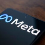 In this photo illustration, the Meta Platforms, Inc. logo is displayed on a smartphone screen.