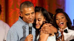 US President Barack Obama hugs his daughter Malia, after singing to her Happy Birthday, at the Fourth of July White House party, while singer Janelle Monáe (R) and singer Kendrick Lamar (L) react, on July 4, 2016, Washington, DC, USA, in the East room of the White House. Malia was born 18 years ago. Guests at the party included military families and staff and their families from throughout the administration. Because of the rain the party was moved from the South Lawn to the East Room of the White House.