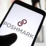 In this photo illustration, a Poshmark Inc. logo is seen on a smartphone screen in front of its website.