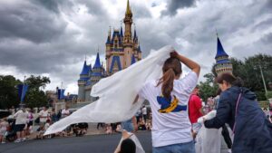 Guests at the Magic Kingdom break out ponchos at Cinderella Castle as bands of weather from Hurricane Helene move through Walt Disney World in Bay Lake, Florida, on Sept. 26, 2024.