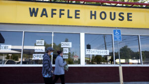 April 27, 2020, Canton, GA: Waffle House restaurants, well-known chain throughout the Southern U.S., were among the first to open to inside dining Monday as Georgia lifted restrictions due to the concerns about COVID-19 infections. .Pictured: Employees at the 24-hour restaurant arrive for their evening shift