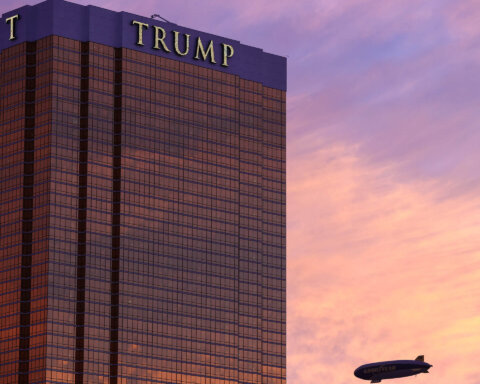 An exterior view of the Trump Hotel as the Goodyear Blimp passes by at sunset in Las Vegas, NV