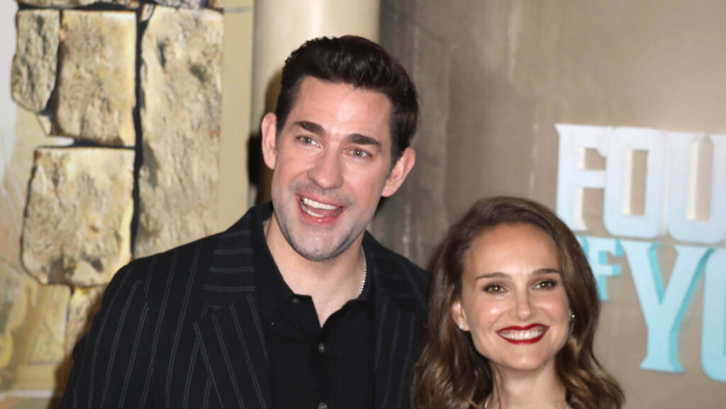 John Krasinski and Natalie Portman smiling at a movie premiere event.