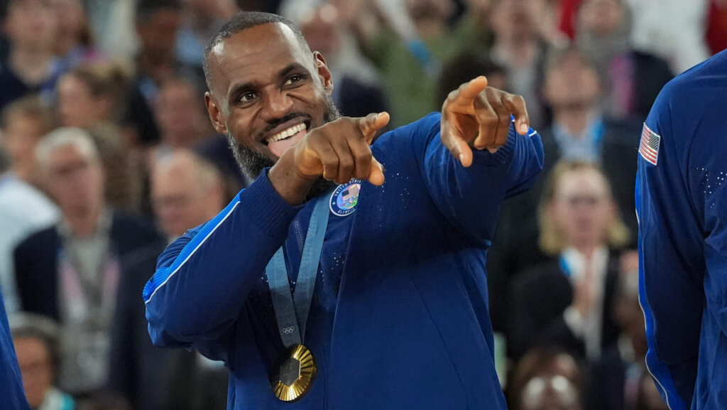 Lebron James of the USA (6) poses on the podium after team USA defeated France 98-87 in the Men's Basketball gold medal game during the Paris 2024 Olympic Games at the Bercy Arena in Paris, France on Saturday, August 10, 2024.