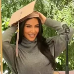 Kim Kardashian putting on her cap at the graduation ceremony. Photo: Simone Harouche/Instagram