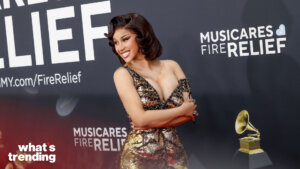 Cardi B smiling in a gold and black sequined dress at the MusiCares Fire Relief event.