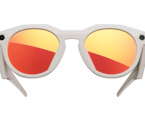 White-framed Oakley sunglasses with orange-red mirrored Prizm lenses and built-in cameras on each side