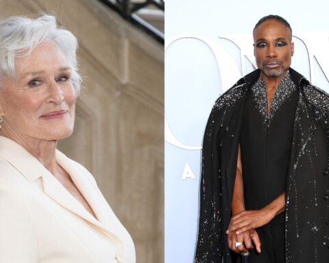Glenn Close in a white blazer and Billy Porter in a black embellished cape at a formal event.