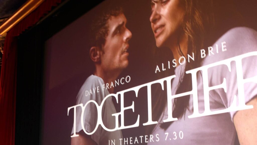 Movie poster for "Together" featuring Dave Franco and Alison Brie, releasing in theaters on July 30.