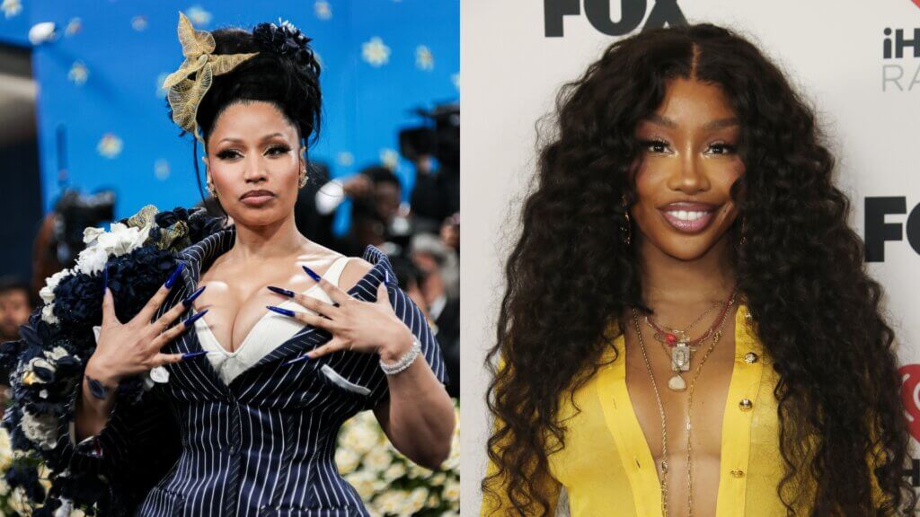 Nicki Minaj in a pinstripe outfit with long blue nails and SZA in a yellow top with layered necklaces at a media event.