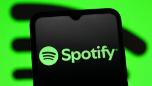 Spotify logo displayed on a smartphone screen with a green background.