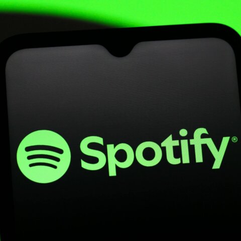 Spotify logo displayed on a smartphone screen with a green background.