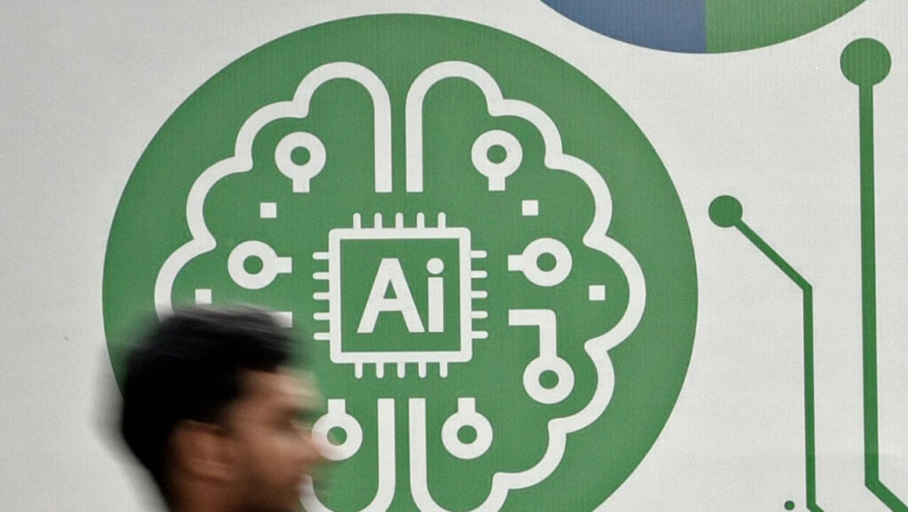 Blurred person walking past a green AI chip and brain circuit illustration on a white wall