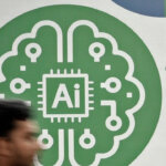 Blurred person walking past a green AI chip and brain circuit illustration on a white wall