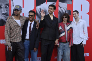 Cast members of the TV show "Duster" posing together at a red carpet event.