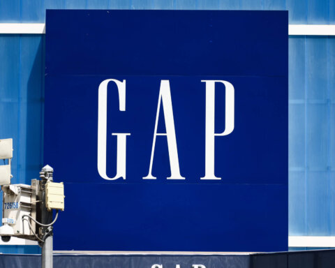 GAP logo on a large blue storefront sign with security cameras in front
