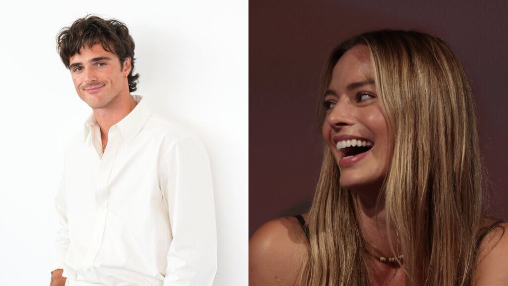 Young man in white shirt smiling and woman with long blonde hair laughing against dark background