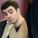 A judge dismissed the terrorism charges against Luigi Mangione in the CEO shooting case, but he still faces multiple other murder and weapons charges.