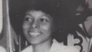 Smiling woman with afro hairstyle in black and white photo