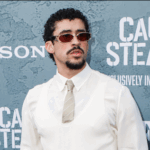 Man wearing sunglasses, white shirt, and beige tie at the "Caught Stealing" movie premiere.