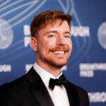 Man in black tuxedo and bow tie smiling at Breakthrough Prize event