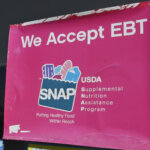 We Accept EBT SNAP sign on a 7-Eleven store window at 1317 E. Washington Blvd, Los Angeles, CA.