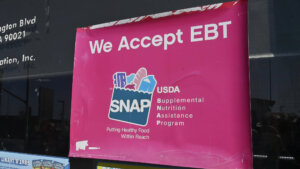 We Accept EBT SNAP sign on a 7-Eleven store window at 1317 E. Washington Blvd, Los Angeles, CA.