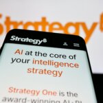 Smartphone screen displaying StrategyB website with text about AI and intelligence strategy, blurred StrategyB logo in background.