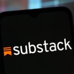 Substack logo displayed on a smartphone screen with a blurred colorful background
