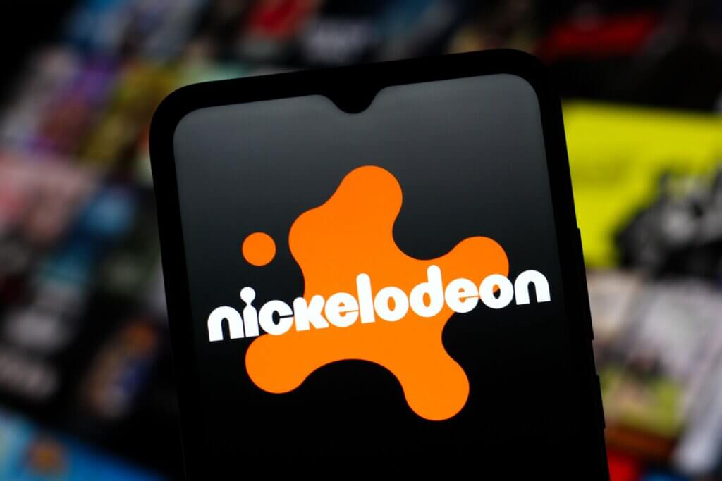 Nickelodeon logo displayed on a smartphone screen with a blurred colorful background.