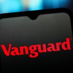 Vanguard logo displayed on a smartphone screen with a blurred colorful background