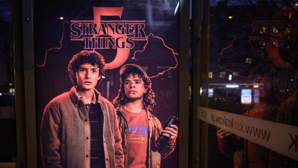 Stranger Things season 5 poster featuring characters Steve Harrington and Dustin Henderson promoting Netflix release dates.