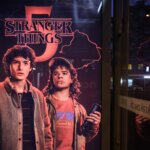 Stranger Things season 5 poster featuring characters Steve Harrington and Dustin Henderson promoting Netflix release dates.