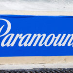 Paramount+ logo in white script on a blue background painted on a wall.