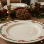 Empty Christmas-themed plate with red bows and green garland pattern on a holiday table setting with pinecones and candle.
