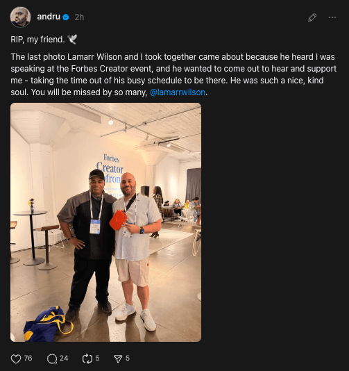 Lamarr Wilson and another man posing together at the Forbes Creator event in a bright indoor space.